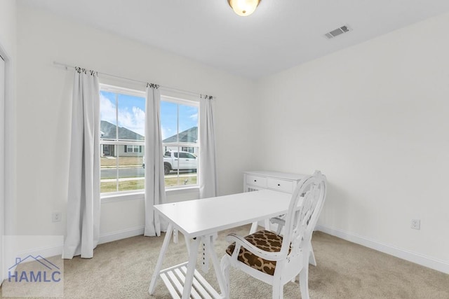 office area with light carpet, visible vents, and baseboards