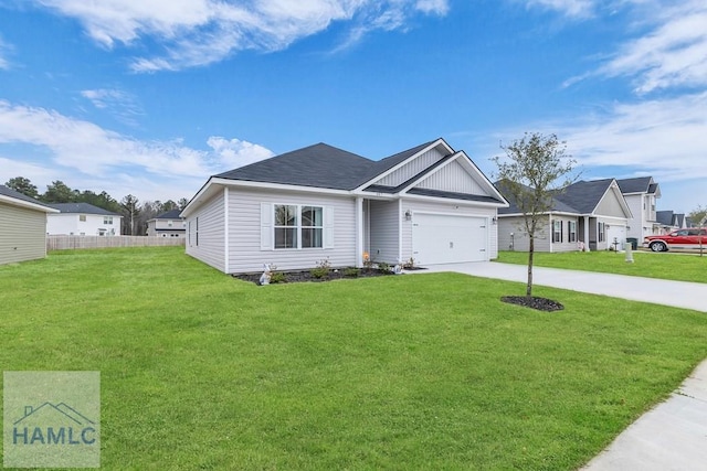 single story home with a garage, a front yard, driveway, and fence