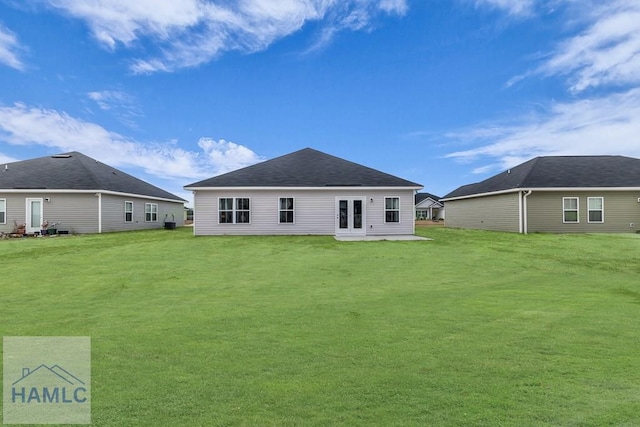 back of property featuring a yard