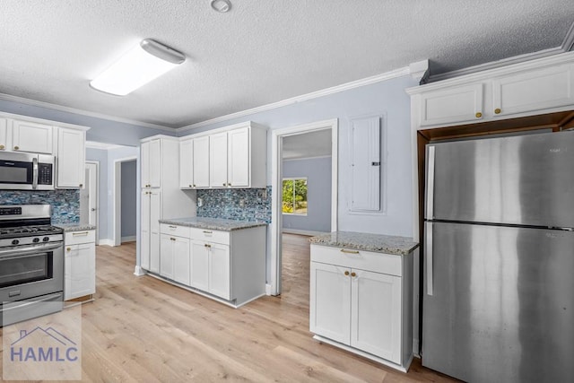 443 Martin Rd, Midway, GA 31320 - kitchen featuring appliances with stainless steel finishes, crown molding, decorative backsplash, a textured ceiling, and white cabinetry