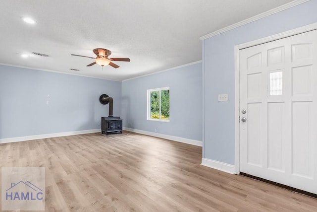 443 Martin Rd, Midway, GA 31320 - entryway with a wood stove, crown molding, light wood-type flooring, ceiling fan, and recessed lighting