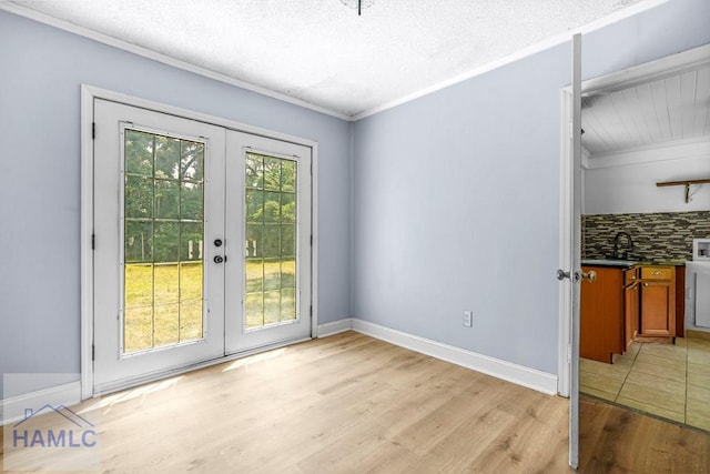 443 Martin Rd, Midway, GA 31320 - unfurnished dining area with french doors, light wood finished floors, ornamental molding, and a textured ceiling