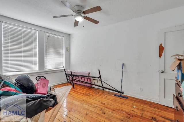 sitting room featuring ceiling fan and light hardwood / wood-style flooring