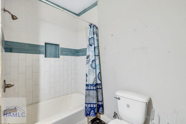 bathroom with shower / bathtub combination with curtain and toilet