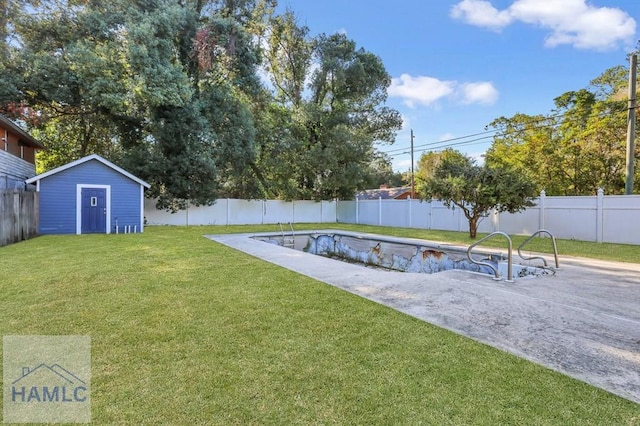 view of yard with a fenced in pool and a storage shed