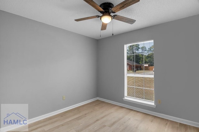 unfurnished room featuring baseboards, a ceiling fan, and light wood-style flooring