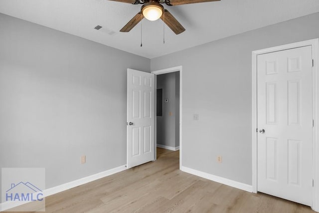 unfurnished bedroom with visible vents, light wood-type flooring, a ceiling fan, and baseboards