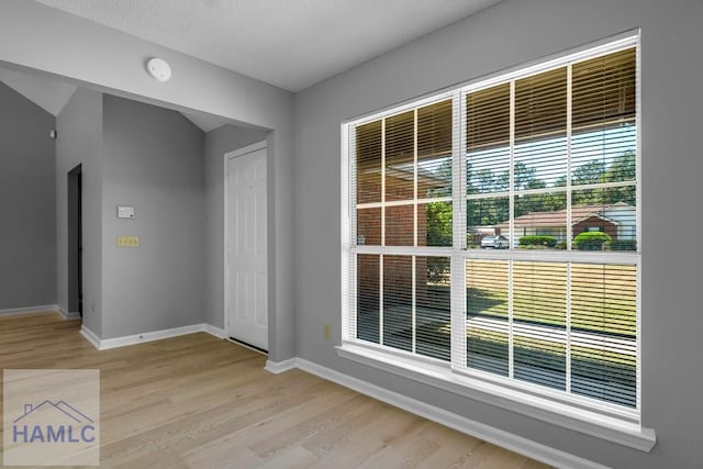 interior space with light wood-style flooring and baseboards