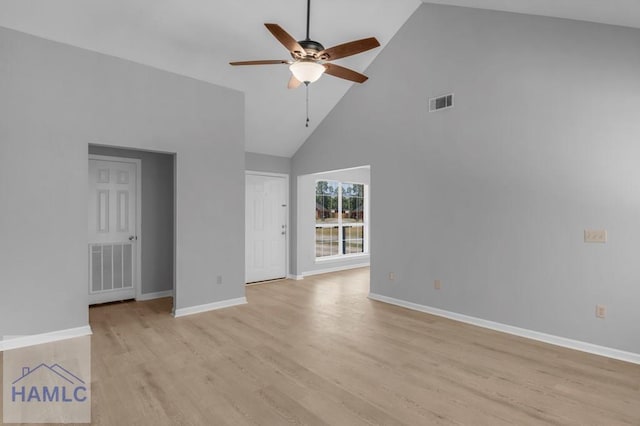 spare room with light wood finished floors, visible vents, a ceiling fan, and high vaulted ceiling