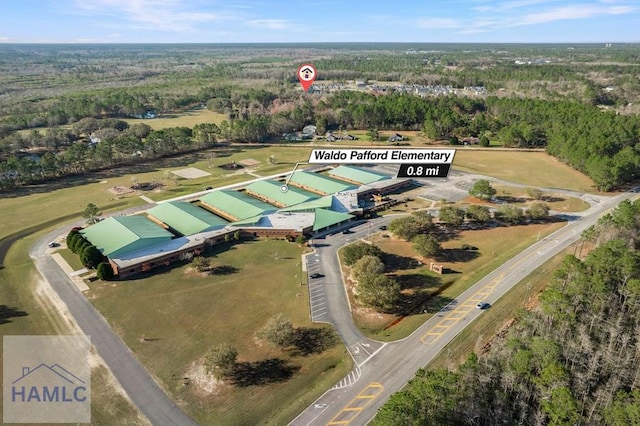 drone / aerial view featuring a forest view