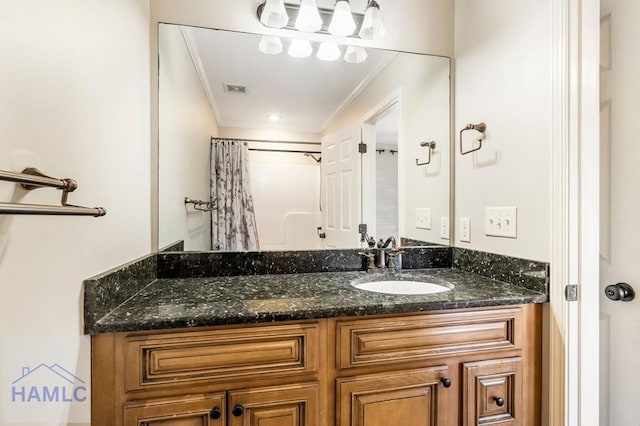 bathroom with curtained shower, visible vents, vanity, and crown molding