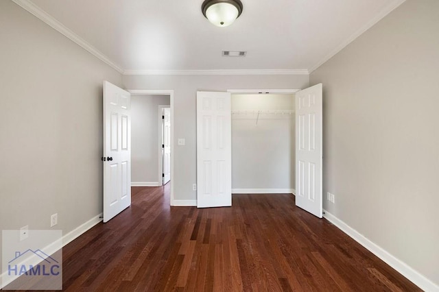 unfurnished bedroom featuring visible vents, wood finished floors, a closet, crown molding, and baseboards