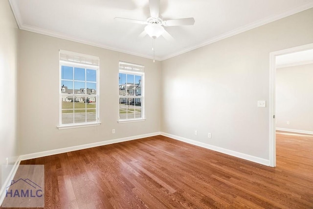 empty room with a ceiling fan, wood finished floors, baseboards, and ornamental molding