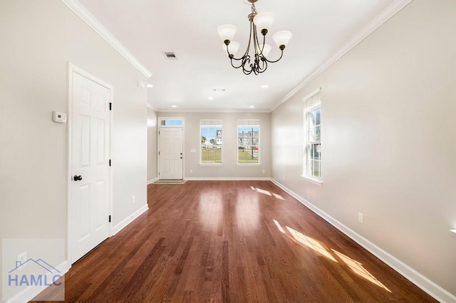 interior space featuring crown molding, baseboards, and wood finished floors