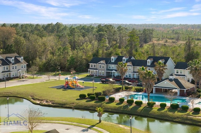 aerial view featuring a view of trees and a water view