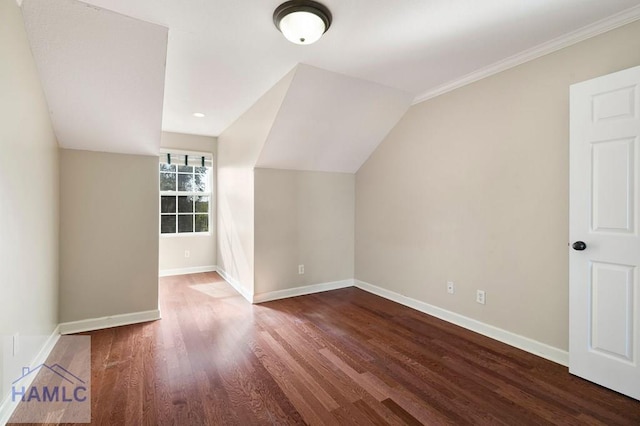 bonus room with vaulted ceiling, wood finished floors, and baseboards