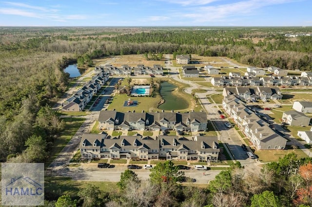 bird's eye view with a water view, a forest view, and a residential view