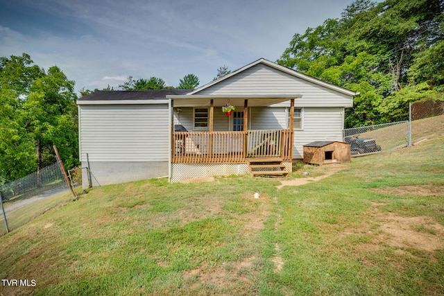 view of front facade with a deck and a front lawn