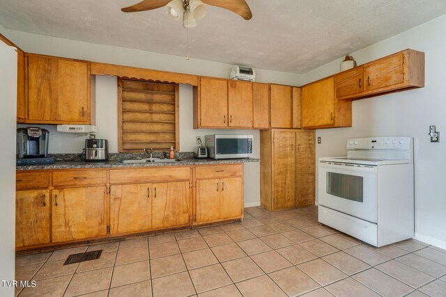 kitchen featuring white range with electric cooktop, sink, ceiling fan, and light tile patterned floors