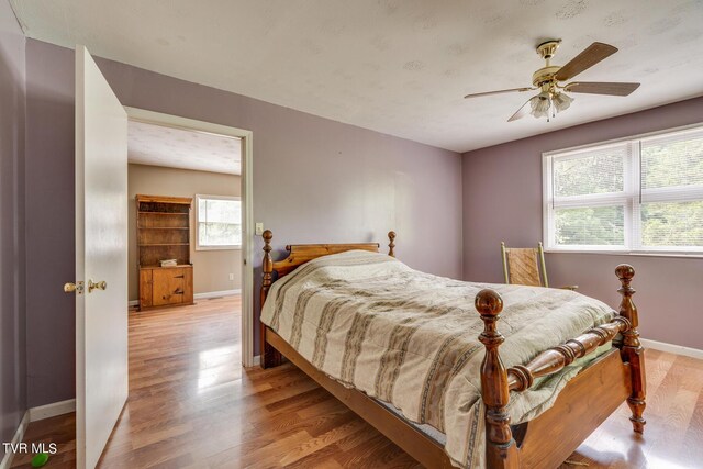 bedroom with light hardwood / wood-style floors and ceiling fan