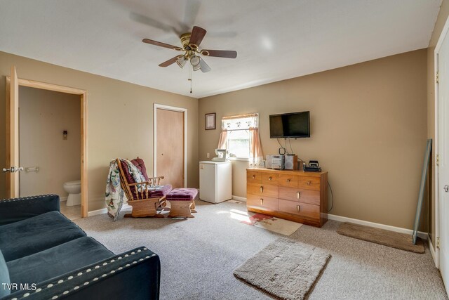 living area featuring light carpet, ceiling fan, and baseboards