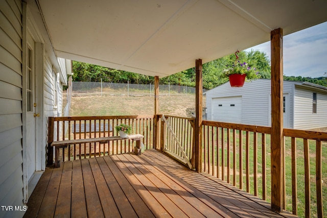 wooden deck with a storage shed and a yard