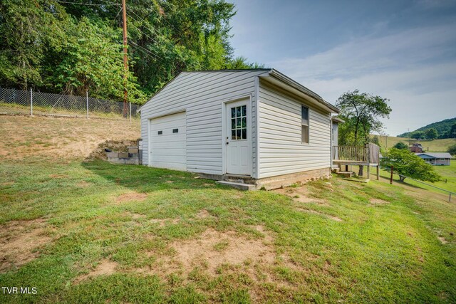 view of outbuilding featuring a garage and a yard