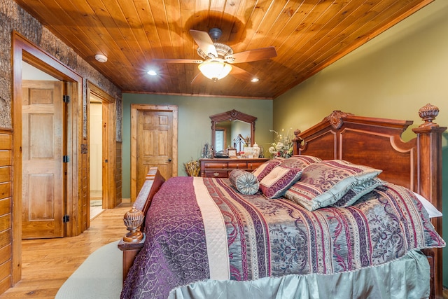 bedroom featuring light hardwood / wood-style flooring, ceiling fan, and wood ceiling