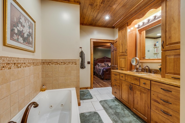 bathroom featuring tile walls, vanity with extensive cabinet space, and tile flooring