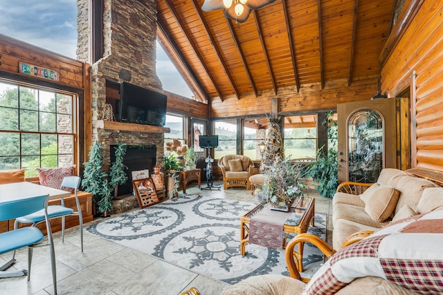 tiled living room featuring high vaulted ceiling, ceiling fan, wood ceiling, beamed ceiling, and a stone fireplace