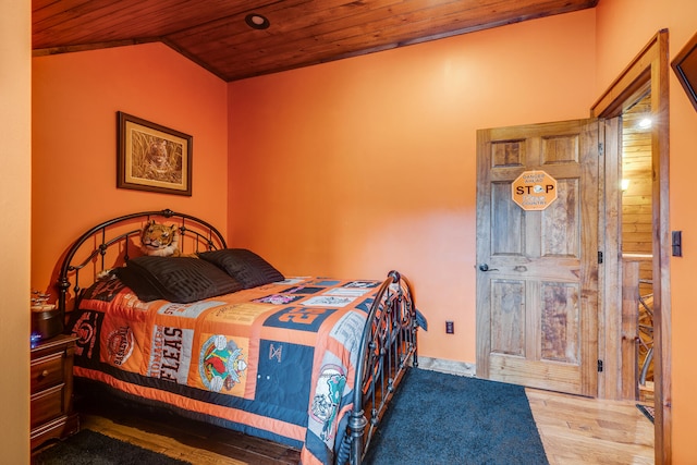 bedroom featuring vaulted ceiling, wood ceiling, and wood-type flooring