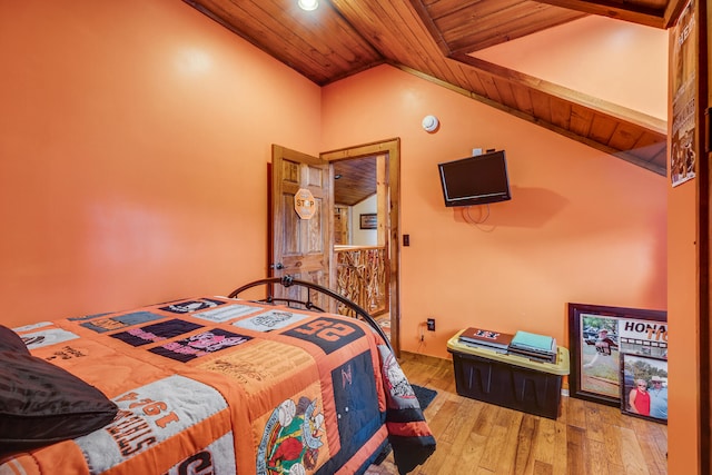 bedroom featuring wooden ceiling, light wood-type flooring, and vaulted ceiling