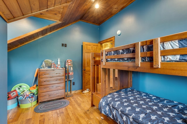 bedroom with light wood-type flooring, wood ceiling, and vaulted ceiling