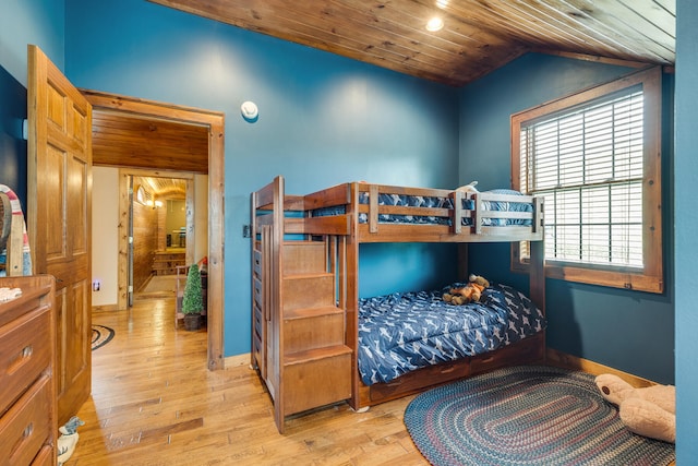 bedroom featuring vaulted ceiling, wooden ceiling, and light hardwood / wood-style flooring