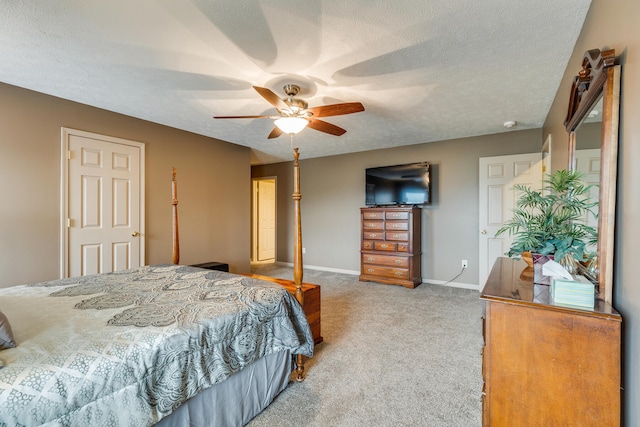 carpeted bedroom with ceiling fan and a textured ceiling