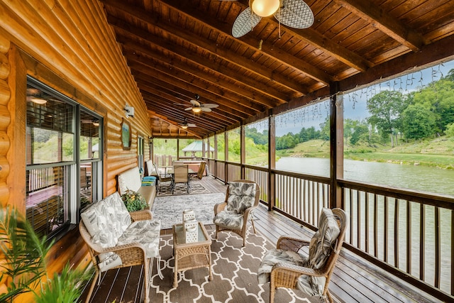 sunroom featuring ceiling fan, lofted ceiling with beams, a wealth of natural light, and wood ceiling