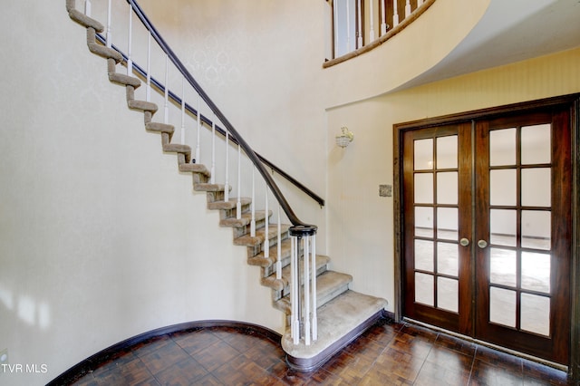 entrance foyer with dark tile flooring and french doors