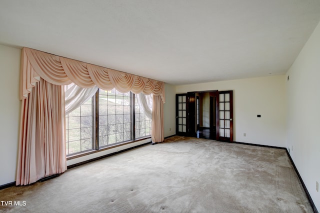 carpeted spare room featuring a baseboard radiator