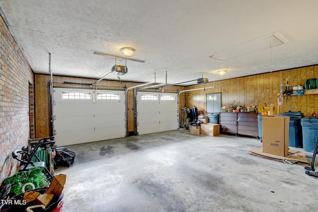 garage with wooden walls and a garage door opener