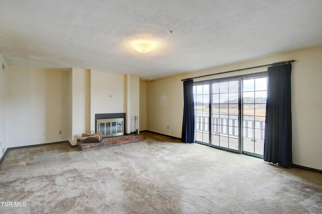 unfurnished living room with light carpet, a textured ceiling, and a fireplace