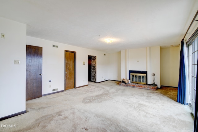 unfurnished living room featuring a fireplace and light carpet