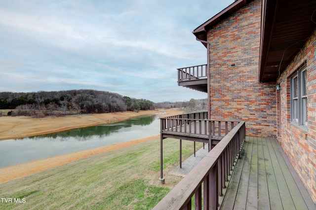 wooden deck featuring a yard and a water view