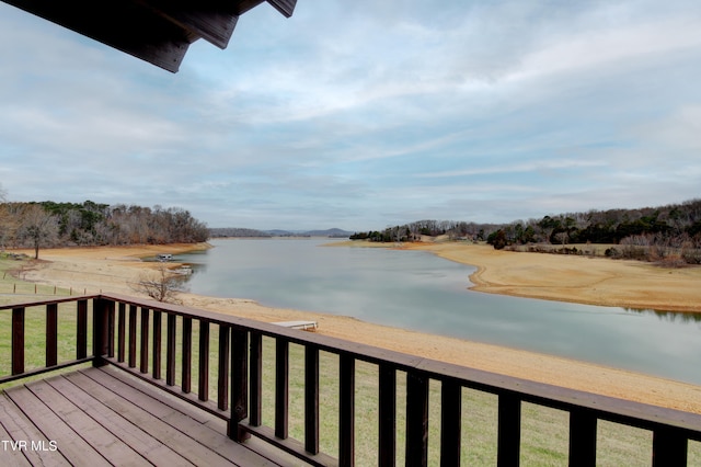 wooden terrace featuring a water view