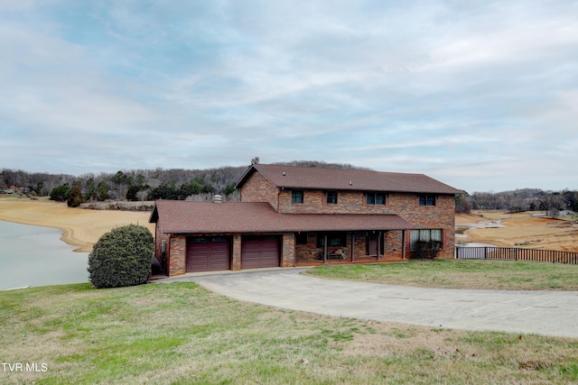 view of front of property with a front lawn and a garage