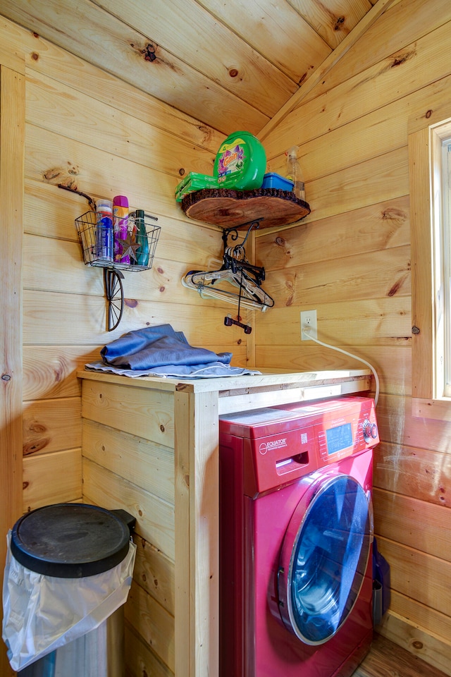 laundry area featuring wooden ceiling, washer / dryer, and wooden walls