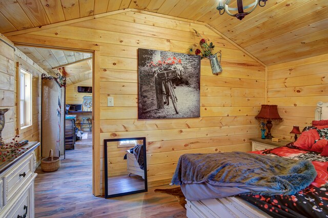 bedroom with hardwood / wood-style floors, lofted ceiling, wood walls, and wood ceiling