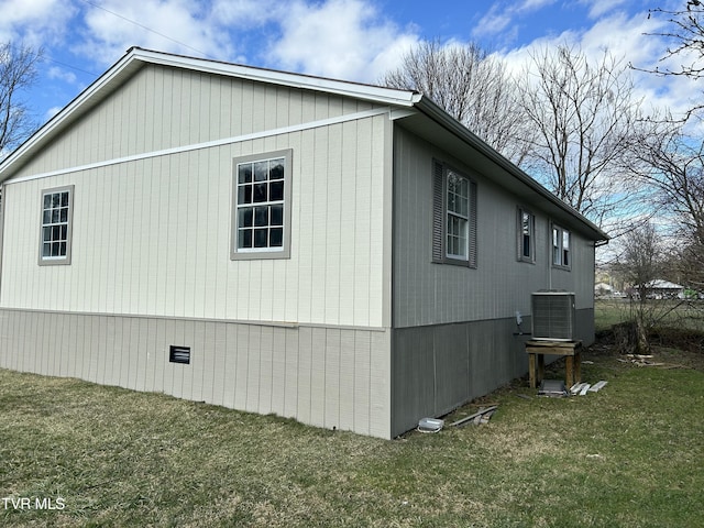 view of side of home featuring a yard and central air condition unit