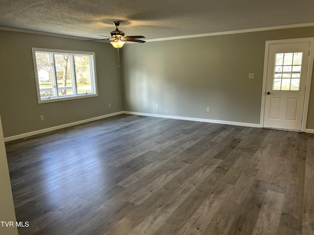 unfurnished room with dark wood-type flooring, ornamental molding, and a textured ceiling