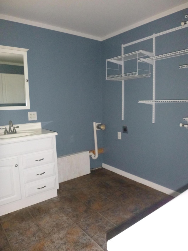 bathroom with ornamental molding, tile flooring, and vanity