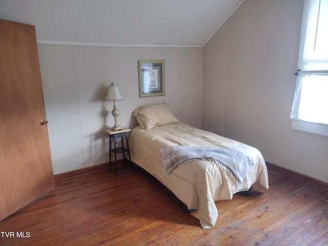 bedroom featuring crown molding and dark wood-type flooring